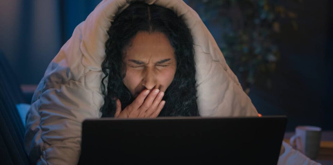 Tired Hispanic girl exhausted sleepy woman fatigued Indian Arabian female at night evening home couch sofa under blanket cover duvet working with laptop watching movie computer addict yawn need sleep. High quality 4k footage