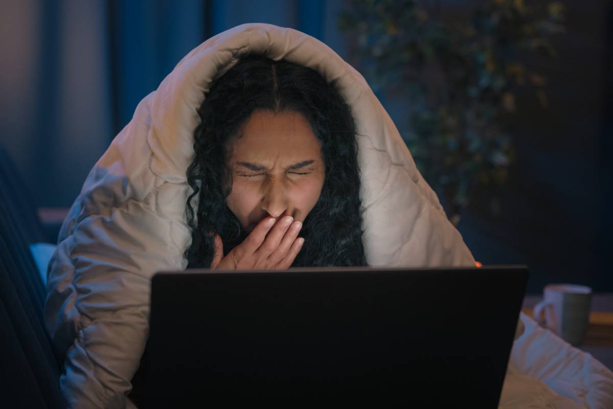 Tired Hispanic girl exhausted sleepy woman fatigued Indian Arabian female at night evening home couch sofa under blanket cover duvet working with laptop watching movie computer addict yawn need sleep. High quality 4k footage